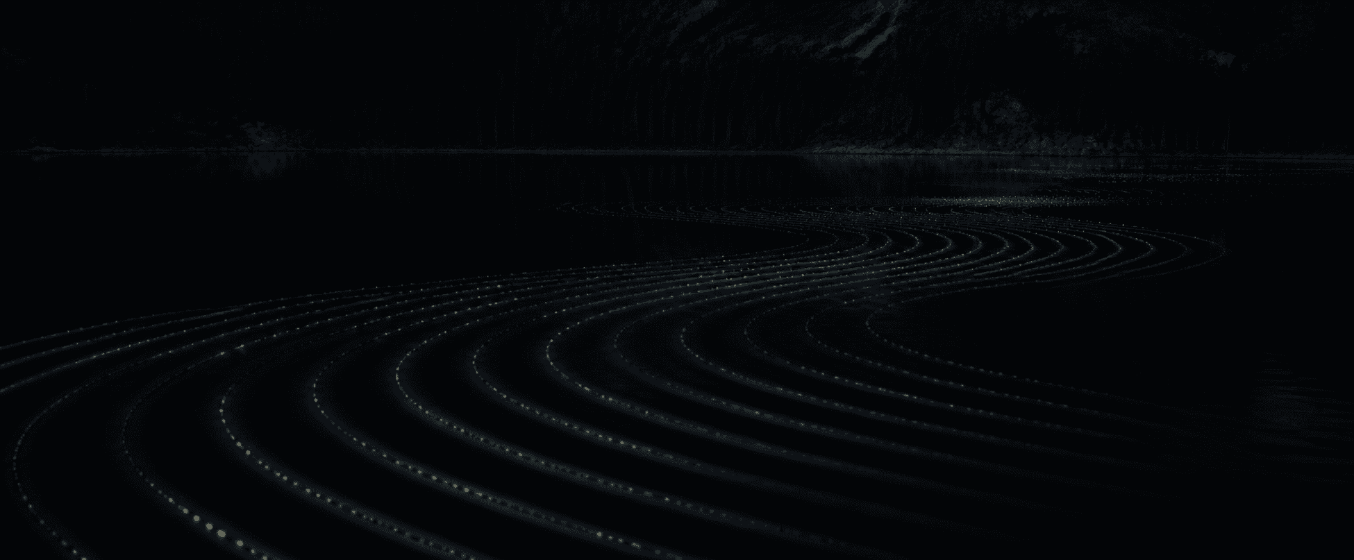 Subtle illuminated sound waves moving across a dark lake